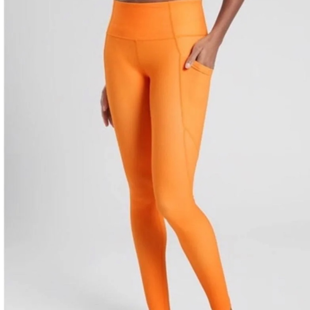 Athleta Stash Pocket Salutation tight Orange Small
